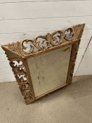 A carved wall mirror 74cm x 95cm