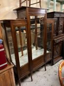A mahogany display cabinet with glazed front and side and mirrored back
