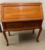 A bureau writing desk possibly rosewood, opening to pigeon holes and drawers (H107cm W90cm D43cm)