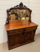 A Victorian chiffonier with mirrored gallery top with carved foliated decoration (H163cm W122cm