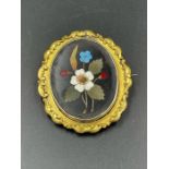 A Pinchbeck brooch with floral design.
