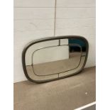 A metal effect octagonal mirror with glass panels to edge 77cm x 107cm