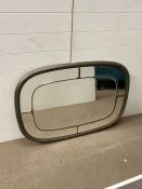 A metal effect octagonal mirror with glass panels to edge 77cm x 107cm