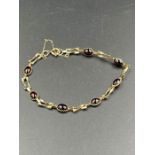 A 9ct gold and garnet bracelet (Approximate Total Weight 4.2g)