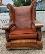 A throne style armchair with oak side supports and replace seat cushions
