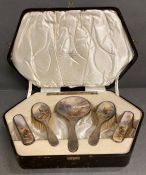 A cased silver mounted dressing table set with highland scene back panels signed Stinton for Royal