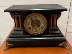 A wooden mantle clock with pillar column sides, this clock has a slate hook