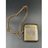 A silver vesta case, inscribed for 1915, on a 9ct gold albert chain (Approximate total weight of