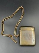 A silver vesta case, inscribed for 1915, on a 9ct gold albert chain (Approximate total weight of