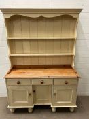 A white pine dresser with plate rack and cupboard under (H188cm W132cm D46cm)