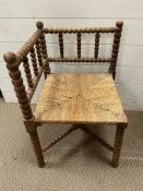 A corner bobbin chair with rush seat