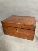 A mahogany writing slope with leather interior slope and various compartments