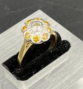 A diamond and citrine daisy style ring on an 18ct gold mount, size O1/2.