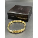 A Limited edition Orient Express 18ct gold bracelet with train and carriage theme (Approximate Total