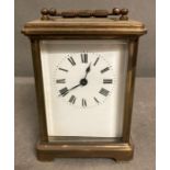 An 20th Century brass cased carriage clock with enamel dial
