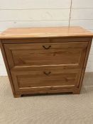 A pine effect two drawer chest (H80cm W89cm D44cm)