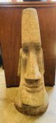 A garden stone Easter Island head