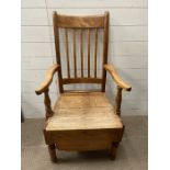 A pine high back farmhouse chair with solid seat and wooden skirt to base
