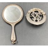 A hallmarked miniature handheld silver backed mirror and a silver brooch hallmarked for 1965 with