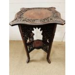 A carved wood side table