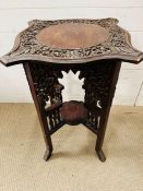 A carved wood side table