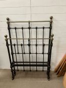 An antique single brass and wrought iron bed frame