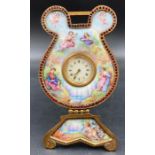 A hand painted porcelain French easel clock with a classical scene