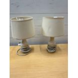 A pair of white bedside lamps