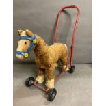A push along vintage toy horse made by pedigree soft toys ltd, steel frame with mohair mix