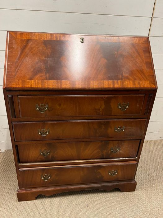 A mahogany bureau with fitted interior of pigeon holes and small drawers on bracket feet (H100cm