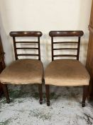 A pair of mahogany dining chairs with ladderbacks