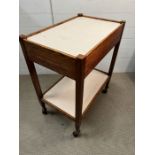 A vintage teak two tier trolley