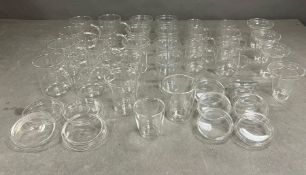 A large selection of glass coffee mugs/cups, with lids and filters