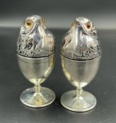 A Pair of silver plated egg warmers in the form of chicks