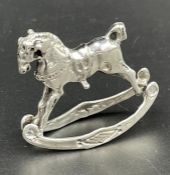 A silver model of a rocking horse