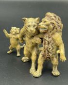 A cold painted bronze lion family, in a group of three