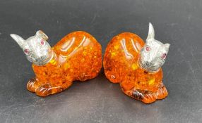 A Pair of amber style, silver plated rabbits