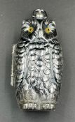 A silver plated owl sovereign case