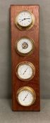 A wall mounted clock, barometer, thermometer, hygrometer set in brass.
