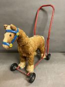 A push along vintage toy horse made by pedigree soft toys ltd, steel frame with mohair mix