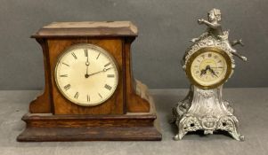 Two mantel clocks, one in an oak case