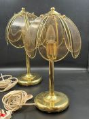 A pair of table lamps with smoked glass shades