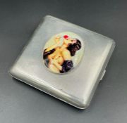 A Hallmarked silver cigareete case with erotic enamel plaque