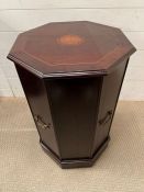 A side table of octagonal shape opening to a shelf (H72cm W46cm)