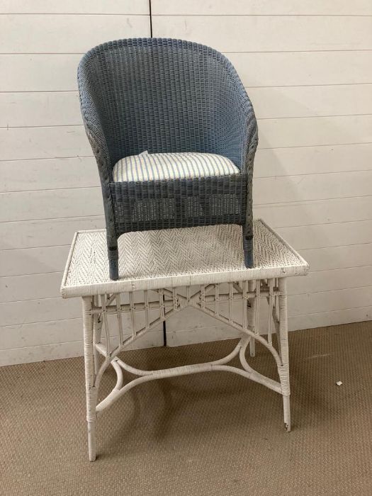 A cane painted table and Lloyd Loom chair