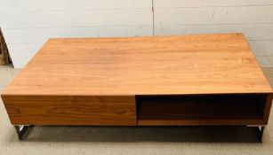 A rectangular low coffee table on chrome legs (H32cm W140cm D80cm)