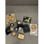 A selection of collectable to include badges, paperweight and replica coins