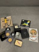 A selection of collectable to include badges, paperweight and replica coins