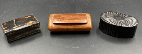 A selection of three snuff boxes, one is a scalloped papier-mache, one in rosewood and the other a