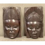 Two pairs of Ebony African face mask, wall hangings